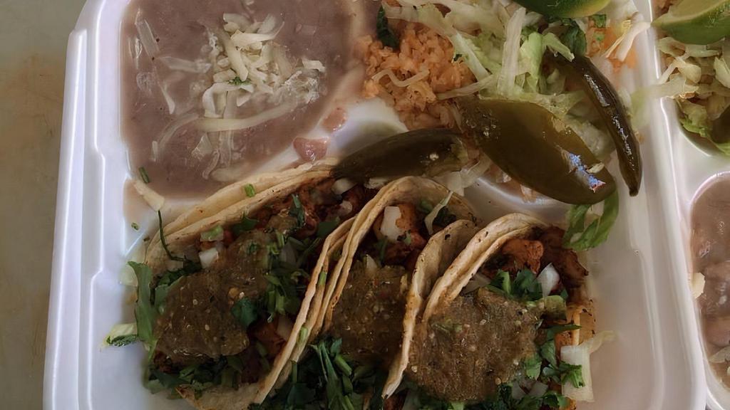 Taco Combo · Three tacos, meat, rice, beans, onion, cilantro, and salsa.