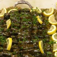 75. Dolma · Vegetarian, gluten free. Stuffed grape leaves with basmati rice and herbs topped with homema...