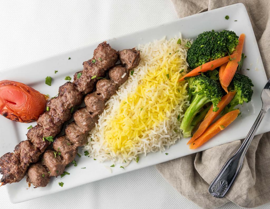 53. Koubideh Kebob · Gluten free. Two skewers of grilled marinated fresh ground beef, served with saffron, basmati rice, grilled tomato and vegetables.