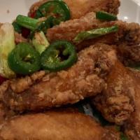 Salt Pepper Wings (10) · Fried chicken wings tossed with our house salt, pepper spices, dry chilis and jalapeno peppers