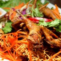 Garlic Quails · Fried quails marinated in garlic, pepper, and thai herbs, served with crispy egg noodle and ...