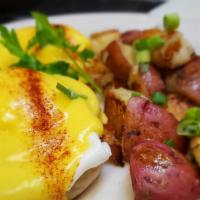 Eggs Benedict · Canadian bacon, poached eggs, English muffin, hollandaise sauce.