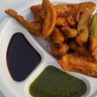 Chilly Pakora · Besan batter chili peppers deep fried with side of chutneys.
