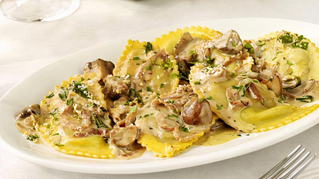 Mushroom Ravioli · Porcini stuffed fresh pasta, caramelized onions, marsala cream sauce (520 cal.).