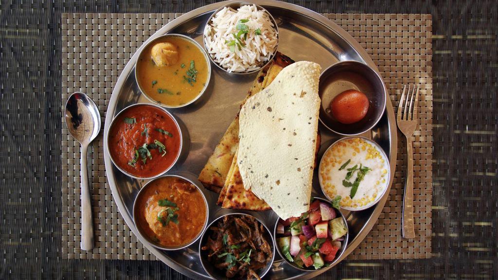Gobi Paratha Thali · Thick gobi (cauliflower) paratha thali served with side of dal (lentil soup), vegetarian curry of the day, sweet of the day and yogurt!
