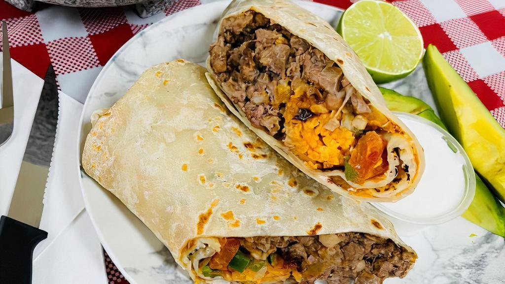 Burrito · Filled with savory filling: vegetables(tomatoes, cheese, avocado), choice of meat (asada, carnitas y pollo), rice and cooked beans.