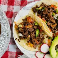 Tacos · Your choice of meat (asada, carnitas y pollo), tortilla, topped with onions, cilantro, pico ...