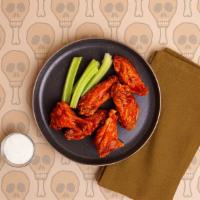 Buffalo Wings · Six crispy chicken wings tossed in a spicy buffalo sauce and served with ranch or blue cheese.
