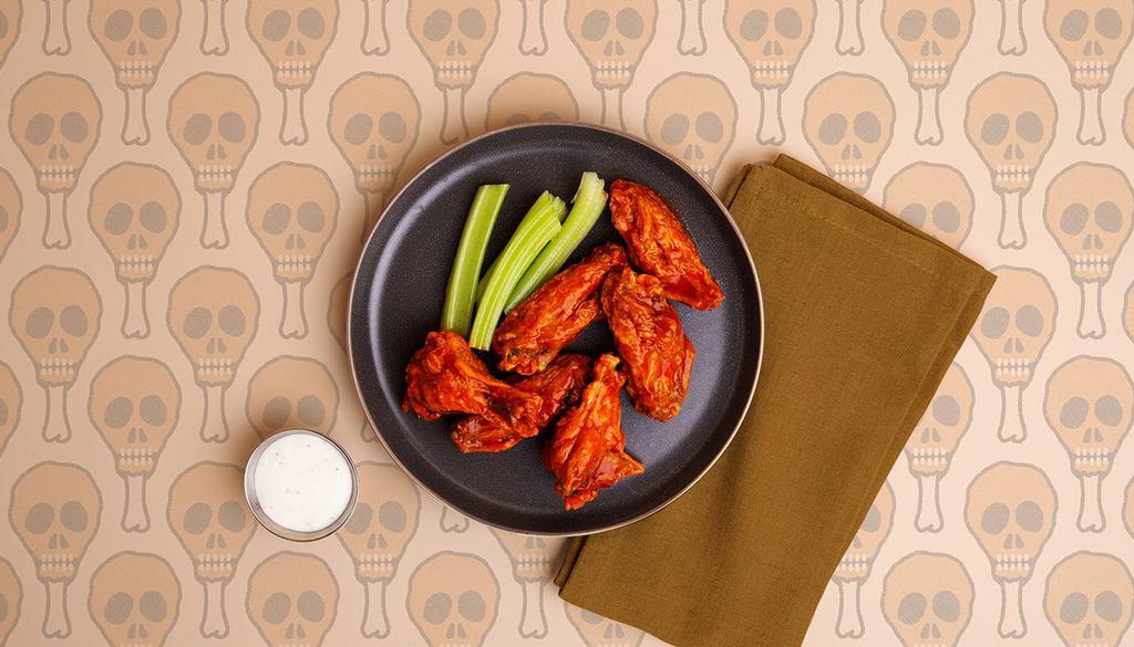 Buffalo Wings · Six crispy chicken wings tossed in a spicy buffalo sauce and served with ranch or blue cheese.