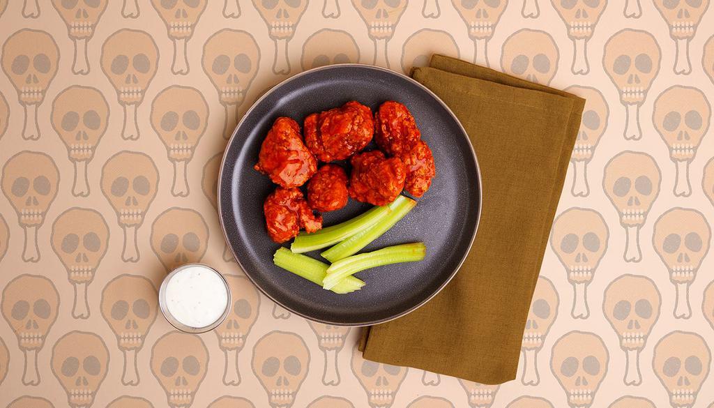 Boneless Buffalo Wings · Six crispy breaded boneless wings tossed in a spicy buffalo sauce and served with ranch or blue cheese.
