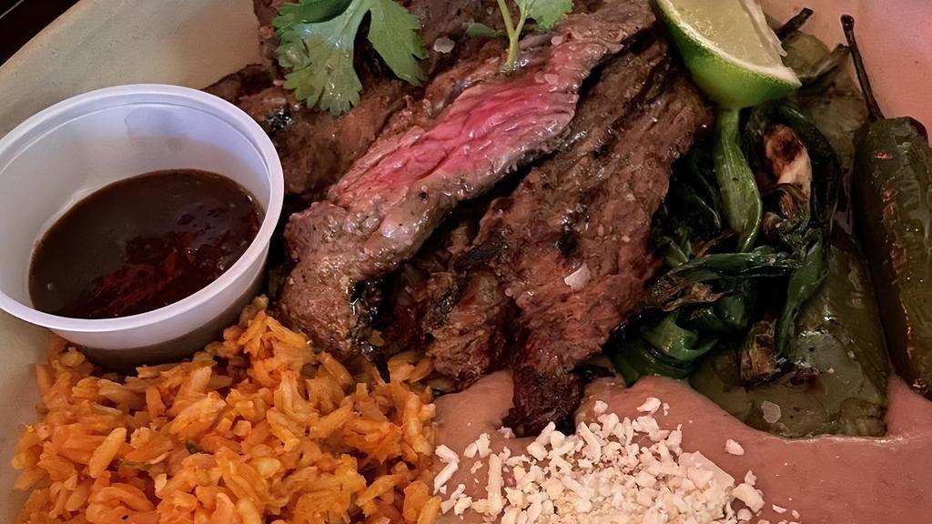 Carne Asada · Skirt steak, nopal, spring onions, chile asado, rice, beans, handmade tortillas.