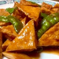 Braised Tofu · Bean curd cut into triangular pieces, deep-fried, braised with vegetables in dark sauce.