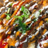 4. Bobcha Tots · Deep fried tater tots with bulgogi beef, kimchi, cheese, green onions, pico de gallo, drizzl...