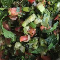 Palestinian Salad · Finely chopped tomatoes, cucumbers, green onions, romaine lettuce, parsley and mint, all tos...