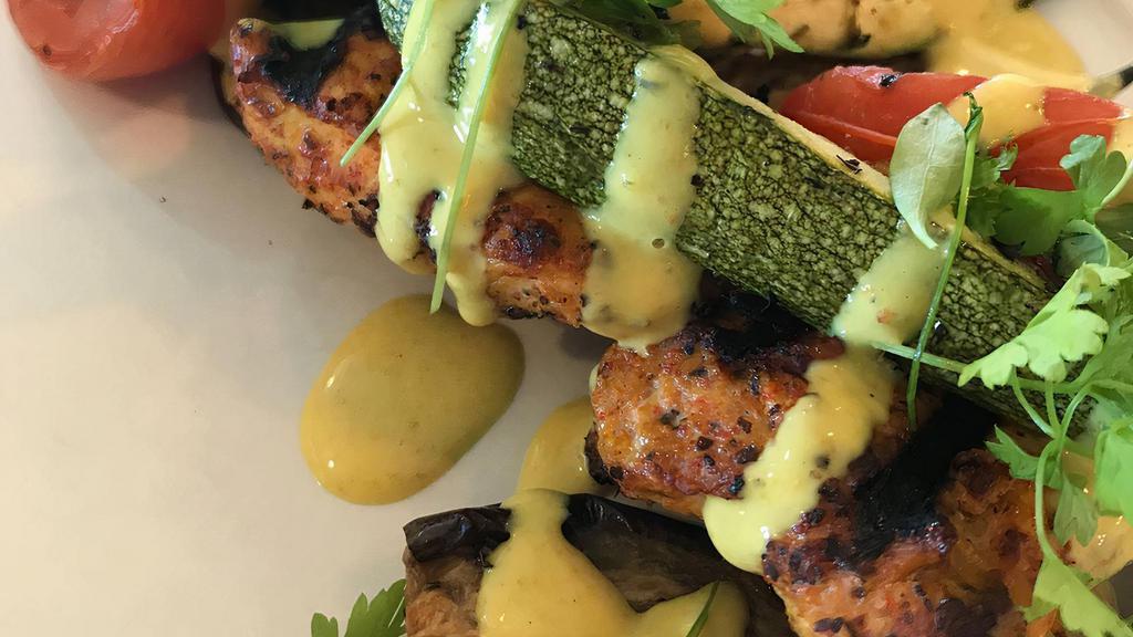 Chicken Skewer · Grilled free-range chicken breast, seasoned with Mediterranean spices and served over roasted eggplant, zucchini and tomatoes.
