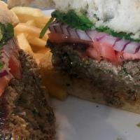 Lamb Burger (Kufta) · Grilled grass-fed beef and lamb seasoned with Mediterranean spices topped with arugula, toma...