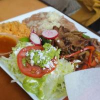 Fajitas · Choice of grilled beef or chicken, grilled onions, bell peppers, rice, beans, guacamole, sou...