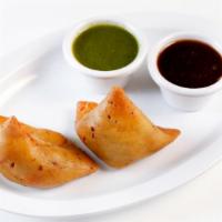 Veg Samosas (2 Pieces) · A special dough pastry stuffed with potatoes and peas served with chutney.
