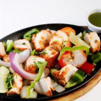 Chicken Tikka Kebab · Boneless juicy pieces of chicken marinated in aromatic Indian herbs and cooked in the clay o...