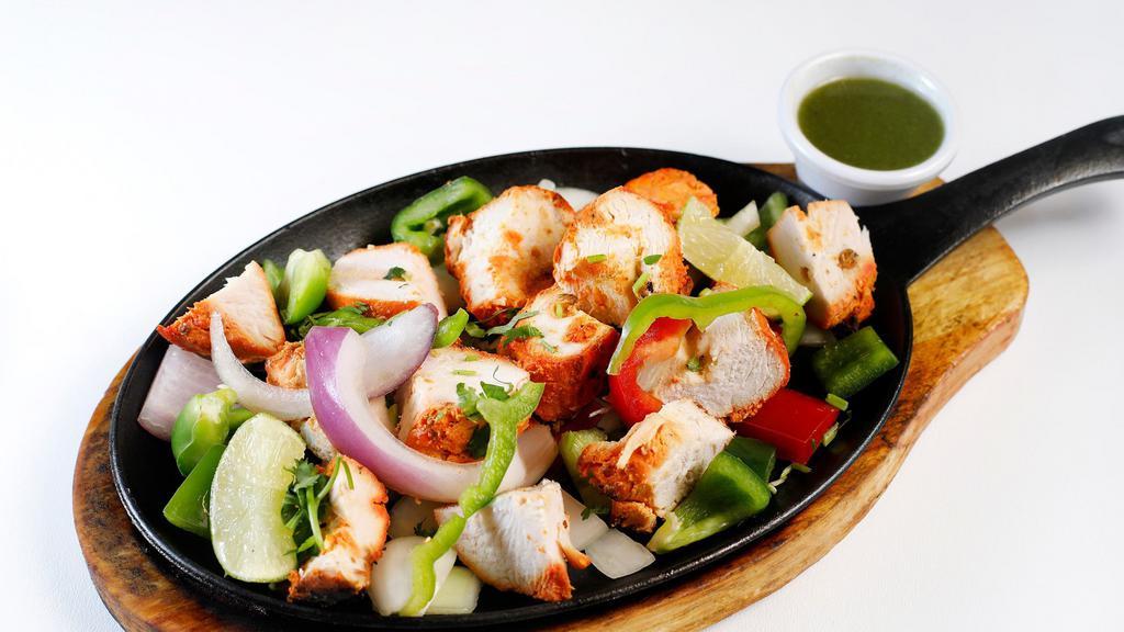 Chicken Tikka Kebab · Boneless juicy pieces of chicken marinated in aromatic Indian herbs and cooked in the clay oven.