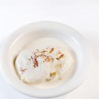 Ras Malai ( 2 pcs) · Rounded patties of curded milk submerged in a light and creamy sauce.