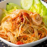 Som Tum (Papaya Salad) · Green papaya, fresh garlic, tomatoes, steamed shrimp, and chopped peanuts tossed in Thai lim...