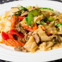 Pad Kee Mow · Stir fry thick rice noodles with garlic sauce, basil, jalapenos, bell peppers, cabbage, carr...