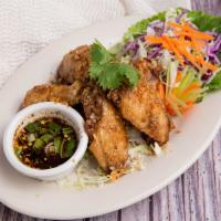 Garlic Wings · Deep-fried marinated chicken wings tossed with garlic, pepper, served with spicy lime sauce.