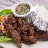 Beef Jerky · Deep-fried marinated beef strips with garlic, pepper and Thai spices, served with spicy lime...