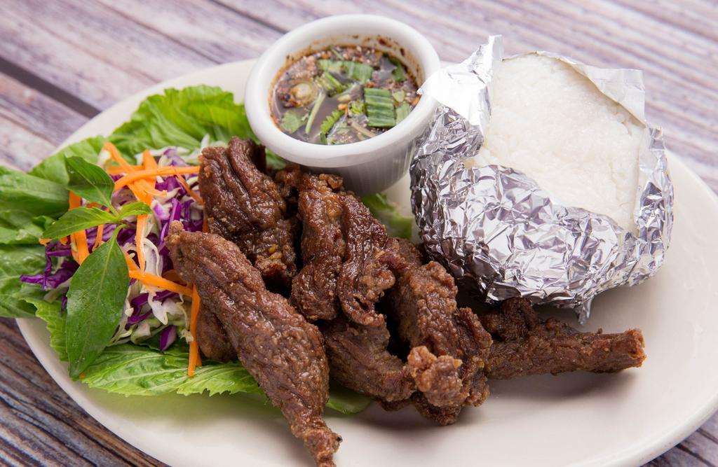 Beef Jerky · Deep-fried marinated beef strips with garlic, pepper and Thai spices, served with spicy lime sauce.