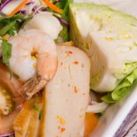 Spicy Seafood Salad · Shrimp, calamari and sliced fish cakes with tomatoes, onion in spicy lime dressing served wi...