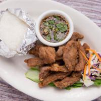 Pork Jerky · Deep-fried marinated pork strips with garlic, pepper and Thai spices, served with spicy lime...