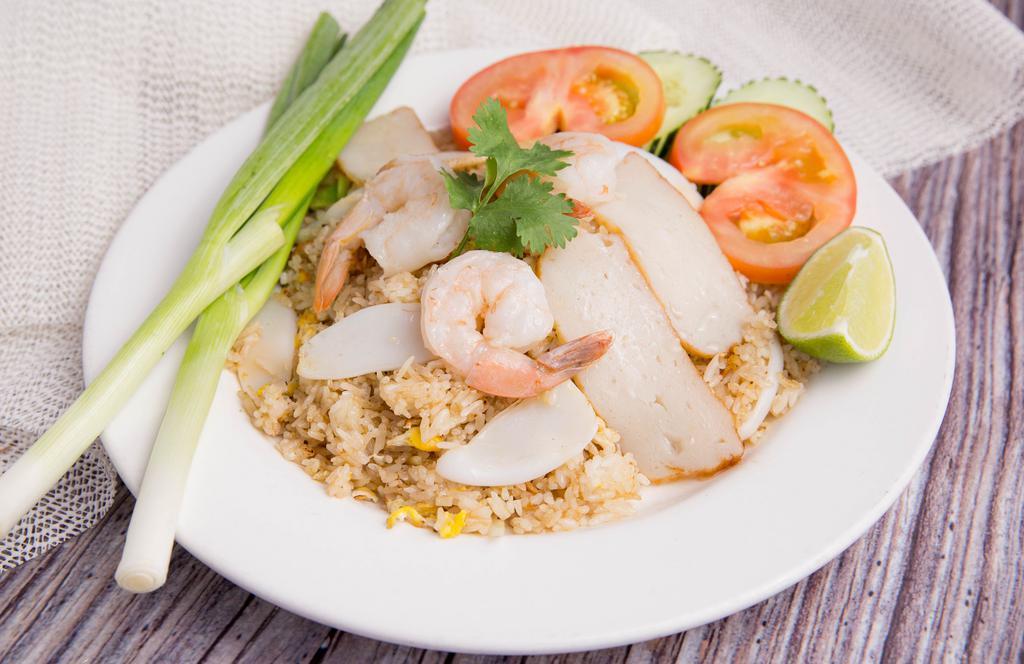Thai Style Fried Rice · Fried rice with your choice of meat or vegetables, egg, white onion, green onion, and tomato topped with cucumber.