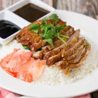 Roast Duck Over Rice · Roasted boneless duck meat with Yao Choy topped with Thai style duck sauce served over steam...