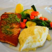 Salmone Alla Griglia · Grilled filet of salmon topped with garlic butter. Served with vegetables & garlic mashed po...