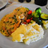 Petto di pollo piccata · Chicken breast white wine, lemon, capers & butter sauce.
Served with vegetables and garlic m...