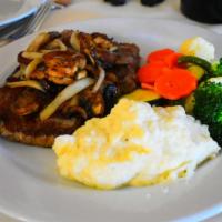 Bistecca di Ribeye · Grilled ribeye steak topped with sauteed mushrooms & onions. Served with vegetables & garlic...