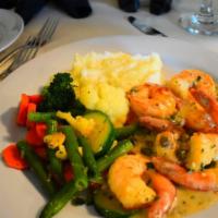 Scampi piccata · prawns sauteed with white wine, lemon, capers & butter sauce.
Served with vegetables and gar...