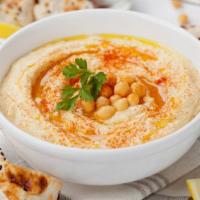 Hummus with Pita · Creamy dip of garbanzo beans, tahini, garlic, lemon juice, and olive oil.