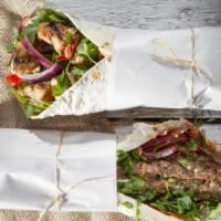 Halal Lamb Shawerma (Doner) Wrap · Thinly shaved halal lamb served with lettuce, tomatoes, parsley, onions, and tahini wrapped ...