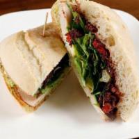 Roasted Turkey Sandwich · Roasted turkey, avocado, mixed greens, sun-dried tomato tapenade and herbed goat cheese spre...
