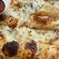 Cheesy Bread (no adds/subs) · Our house dough with garlic and herb olive oil/persilade and our house buffalo mozz blend sh...