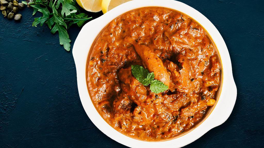 House Special Andhra Chicken Curry · Fresh Chicken with Bones cooked with Onions, Tomato Sauce, Poppy Seeds, Coconut and Cashews