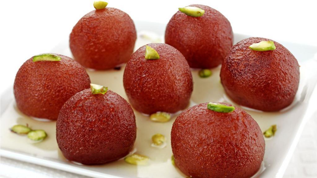 Desi Jamun · Round and Soft melt-in-mouth Dumplings made with Powdered Milk and Baking Powder deep fried and dropped into simmering Sugar Syrup served hot.