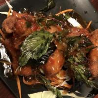 Crispy Wings · Deep fried chicken wings tossed in tangy sauce topped with crispy basil
