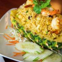 Pineapple Fried Rice · Carefully scooped-out fresh pineapples with a filling of fried rice with prawns, chicken, eg...
