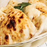 Plain Naan · Delicious while leavened bread baked in clay oven.