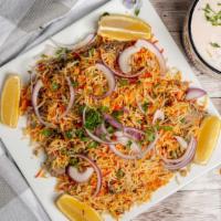 Lamb Biryani · Spiced lamb cooked with basmati rice, onions, bell pepper and nuts.