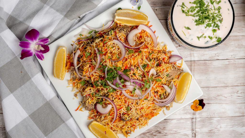 Lamb Biryani · Spiced lamb cooked with basmati rice, onions, bell pepper and nuts.