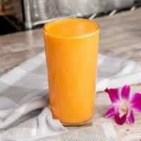 Mango Lassi · Refreshing blend of mangoes and yogurt with a touch of cardamom.